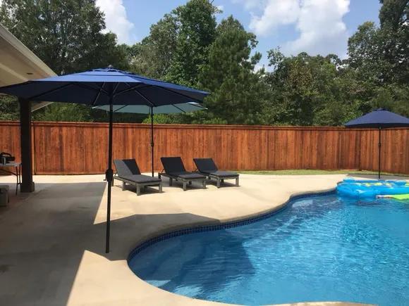 custom stained pool and patio privacy fence by Frank Breaux's Fence